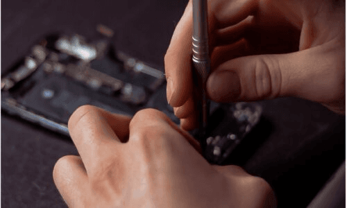 Close-up of hands repairing a smartphone